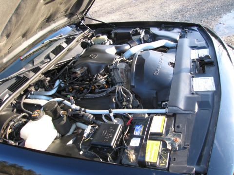 1991 Ford LTD Crown Victoria - The engine bay of a vehicle, showing various components and wiring.