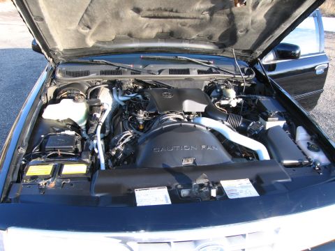 1991 Ford LTD Crown Victoria - Engine bay of a 1991 Ford Crown Victoria LTD, showing the V8 engine and surrounding components.