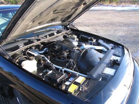 1991 Ford LTD Crown Victoria - Engine compartment of a 1991 Ford Crown Victoria LTD, showing the V8 engine and various components under the open hood.