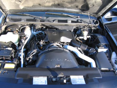 1991 Ford LTD Crown Victoria - The engine bay of a vehicle is shown with various components and a "CAUTION FAN" warning label.