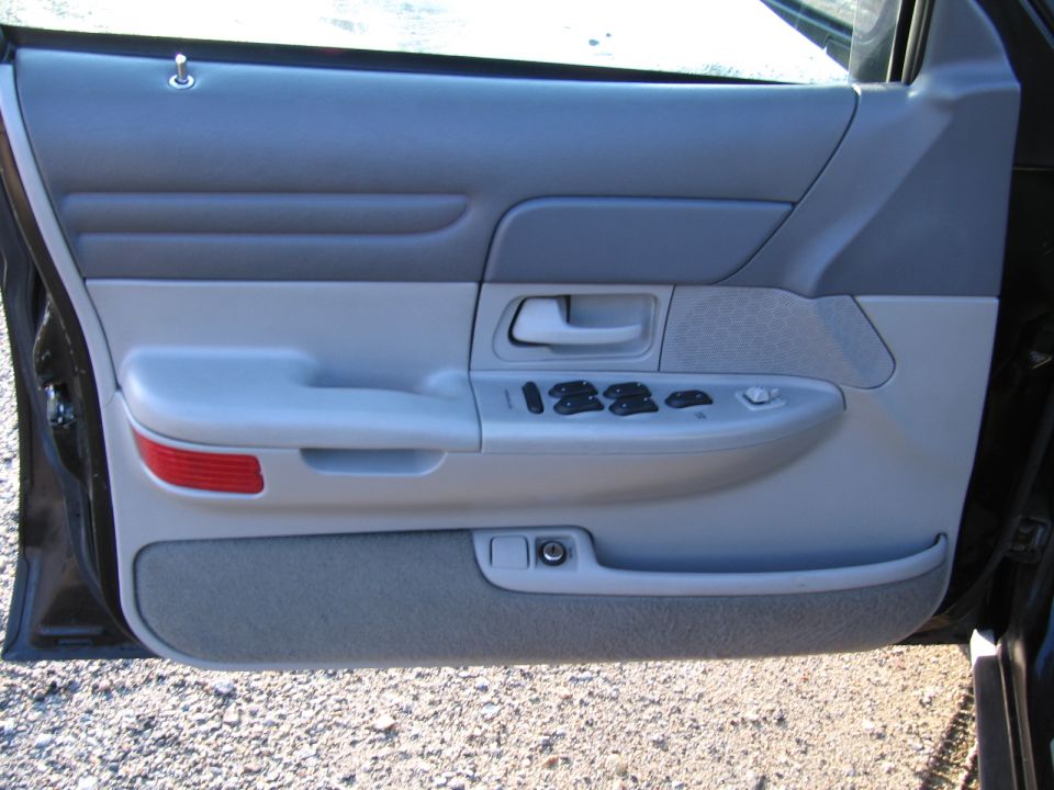 1991 Ford Crown Victoria LTD interior door panel with window controls and red reflector