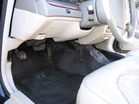 1991 Ford LTD Crown Victoria - Interior view of a car's driver side, focusing on the floor pedals and seating area.