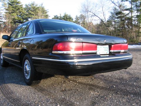 1991 Ford LTD Crown Victoria - The rear of a black Ford Crown Victoria is shown, with a license plate visible.
