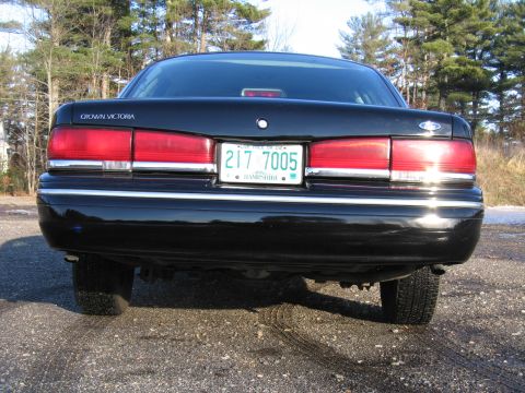 1991 Ford LTD Crown Victoria - Rear view of a black 1991 Ford Crown Victoria sedan parked outdoors.