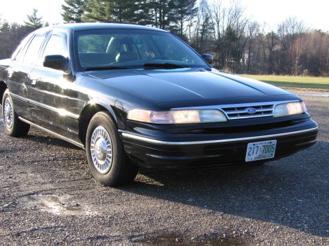 1991 Ford LTD Crown Victoria - This 1991 Ford Crown Victoria LTD sedan is shown from a 3q-front angle, displaying its distinctive grille and headlights.
