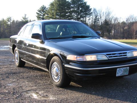 1991 Ford LTD Crown Victoria - Black 1991 Ford Crown Victoria LTD sedan parked outdoors on a gravel surface.