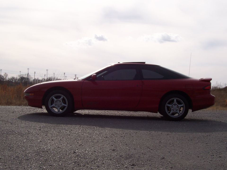 Red 1996 Ford Probe coupe side view
