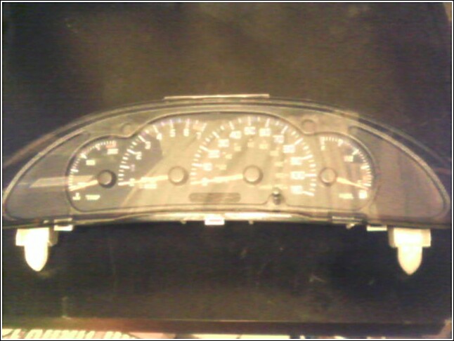 Dashboard instrument cluster with speedometer, tachometer, and fuel gauge