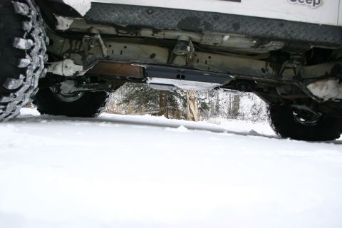 2003 Jeep TJ - Undercarriage view of a 2003 Jeep TJ parked in the snow.