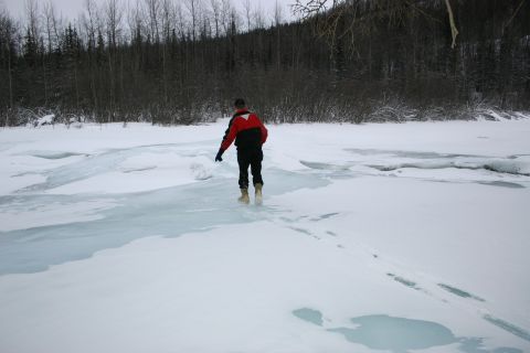 2003 Jeep TJ - A person walks across a frozen body of water, leaving footprints in the snow.