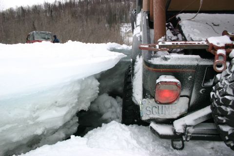 2003 Jeep TJ - A 2003 Jeep TJ navigates through a snowy landscape, with another Jeep visible in the distance.