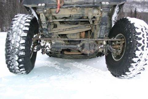 2003 Jeep TJ - The underside of a vehicle with large tires is visible, covered in snow.