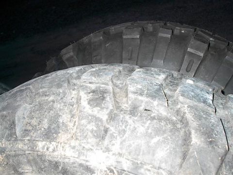 2001 Dodge 1500 - A close-up view of a white, textured surface, which could be snow or part of a tire, against a dark background.