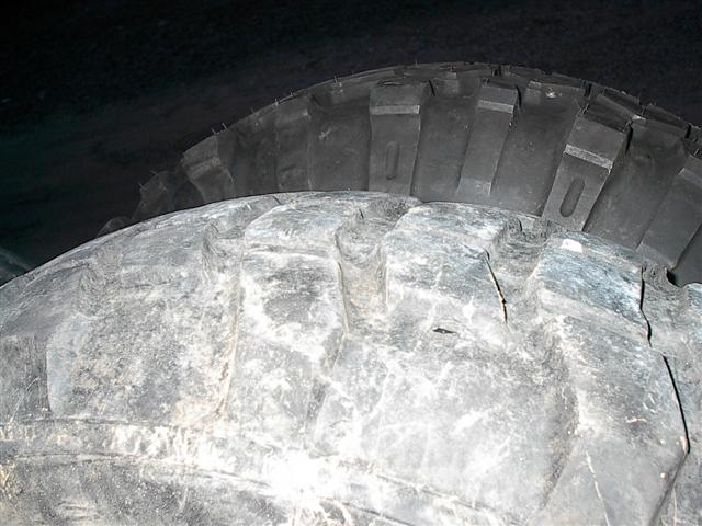 Close-up of a white textured surface, possibly snow or a tire