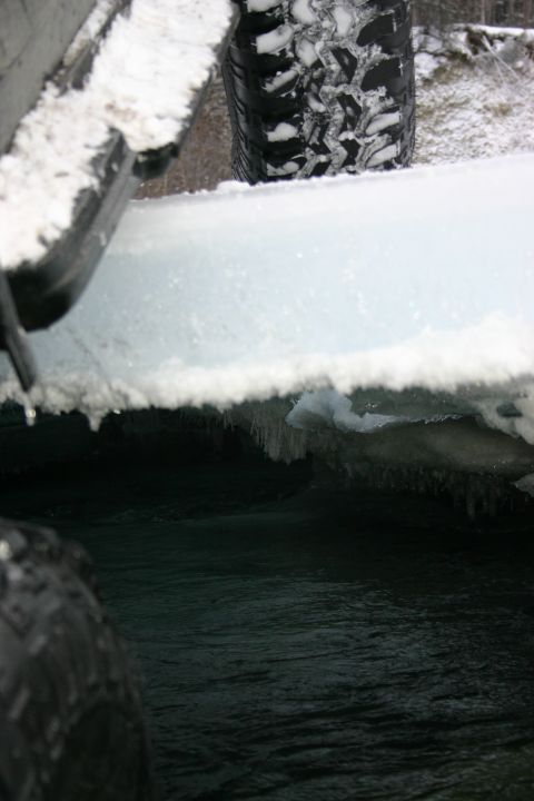 2003 Jeep TJ - A vehicle tire is partially visible in a snowy environment, suggesting winter conditions.