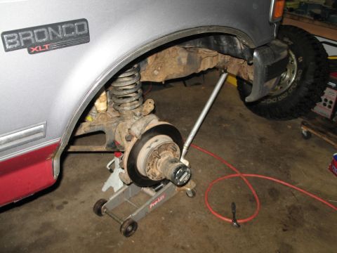 1995 Ford Bronco - Front wheel bearing assembly of a 1992 Ford Bronco XLT, showing suspension and brake components.