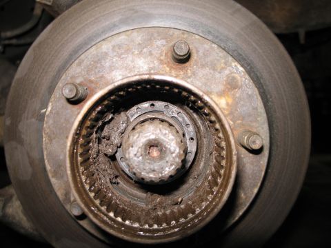 1995 Ford Bronco - Wheel bearing assembly showing signs of wear and accumulated grease.