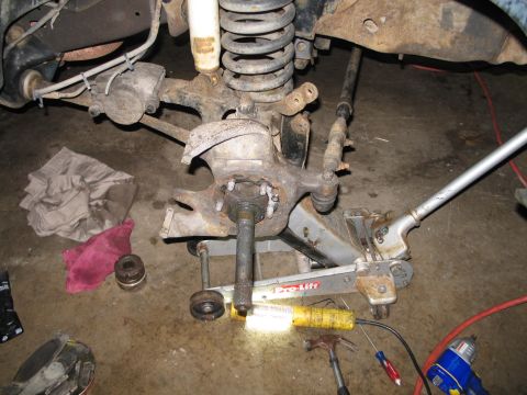 1995 Ford Bronco - Close-up of a disassembled vehicle wheel hub and suspension system, likely from the 1990s.