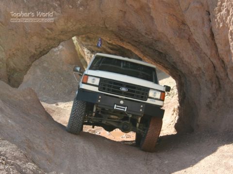 1988 Ford Bronco - This 1988 Ford Bronco is shown driving through a tight passage in a rocky landscape.