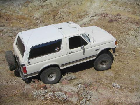 1988 Ford Bronco - This white Ford Bronco is seen from a high angle on a dry, rocky terrain.