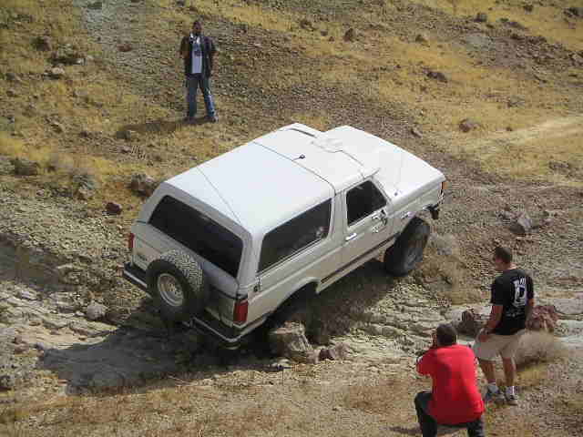 White 1988 Ford Bronco navigating rocky terrain