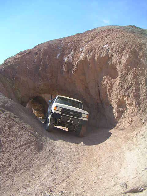 1988 Ford Bronco - This 1988 Ford Bronco navigates a narrow passage in a rocky desert landscape.