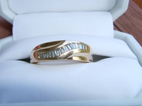 1990 Ford Bronco - Gold ring with baguette diamonds displayed in a white jewelry box.