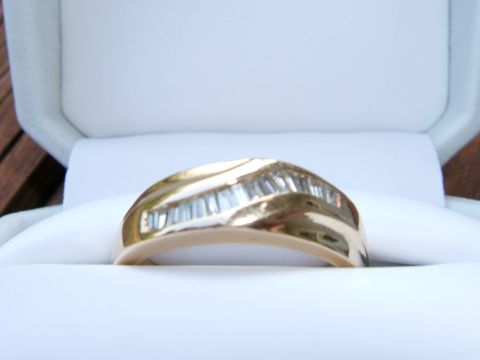 1990 Ford Bronco - Gold ring with baguette diamonds displayed in a white jewelry box.