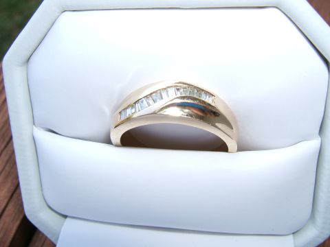 1990 Ford Bronco - A gold ring with baguette diamonds is displayed in a white jewelry box.