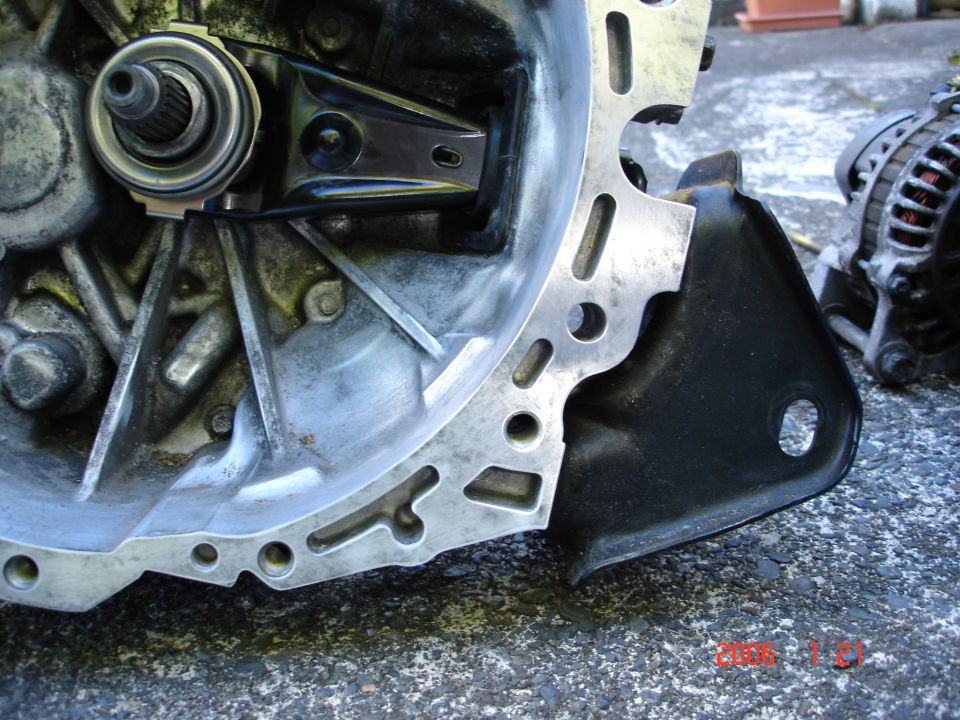 Transmission bell housing and alternator assembly