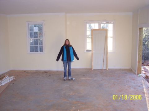 1987 Toyota 4Runner - A person stands in an unfinished room, possibly a garage or house under construction, with windows and a door visible.