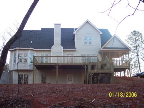 1987 Toyota 4Runner - A large house with a deck and screened porch is viewed from the backyard.