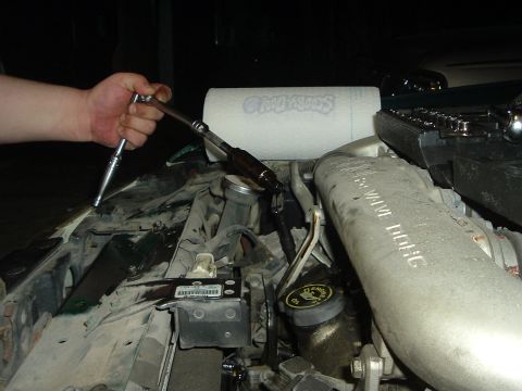 1993 Ford Taurus - Someone is working on the engine, possibly changing oil or a filter.