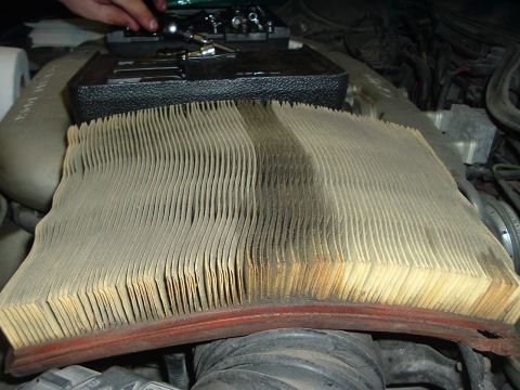 1993 Ford Taurus - A very dirty air filter is shown in the engine compartment, indicating a need for replacement.