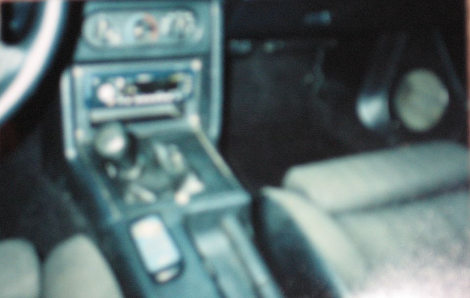 1990 Ford Mustang interior with automatic shifter and dashboard