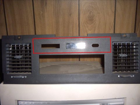 1991 Ford LTD Crown Victoria - Dashboard trim piece with air vents and openings for radio and controls.