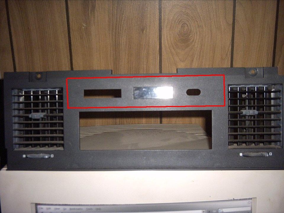 Car dashboard trim piece with two air vents and openings for radio/controls