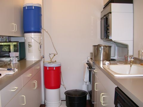 1995 Ford Bronco - A home brewing setup is arranged on a kitchen counter, stacked coolers and tubing for liquid transfer.