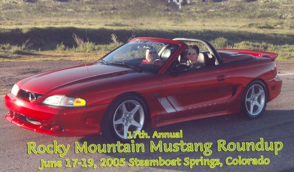Red convertible Mustang with two people inside, driving on a road. Text overlay says '17th. Annual Rocky Mountain Mustang Roundup June 17-19, 2005 Steamboat Spr'