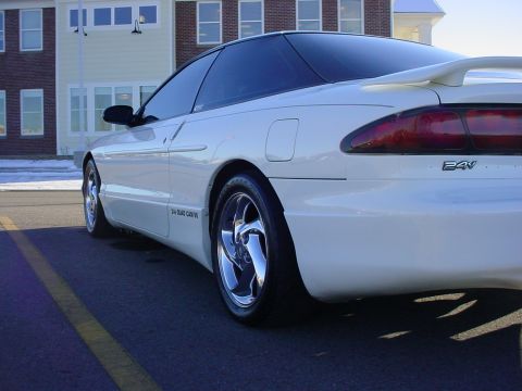 1996 Ford Probe - Rear three-quarter view of a white 1996 Ford Probe coupe with a spoiler and chrome wheels.
