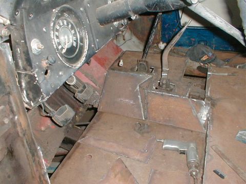 1968 Ford Bronco - Metal floor panels and bricks are visible in this close-up shot.