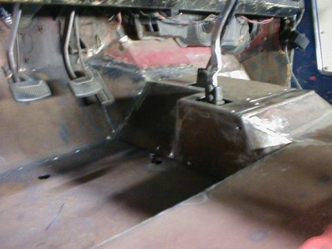 1968 Ford Bronco - The interior of a vehicle, showing seats and dashboard area with clutter.