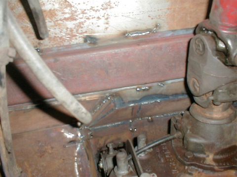 1968 Ford Bronco - A close-up view of a vehicle's undercarriage, showing a section of the floor pan and supporting metal structures.