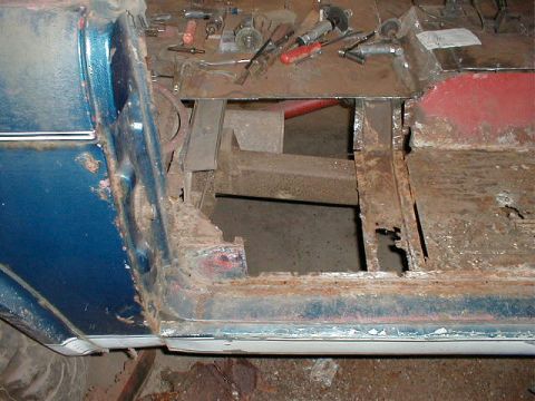 1968 Ford Bronco - The floor pan of a vehicle shows significant rust and damage, indicating a need for repair or replacement.