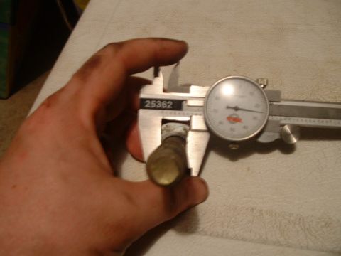 1995 Ford Bronco - Measuring a brass part with a dial caliper, part number 25362 visible.