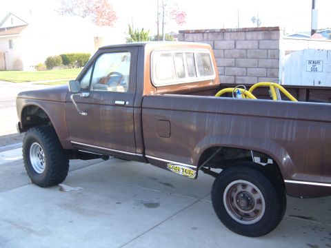 1985 Ford Ranger - This 1985 Ford Ranger pickup truck is shown from the side, a brown exterior and a yellow roll bar visible in the bed.