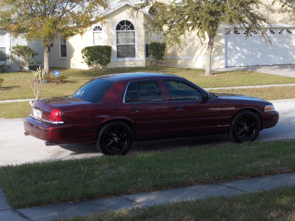 Maroon 2004 Ford Crown Victoria parked on a residential street