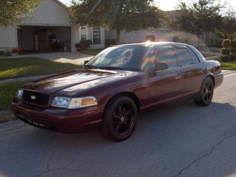2004 Ford Crown Victoria - Maroon 2004 Ford Crown Victoria sedan parked on a residential street.