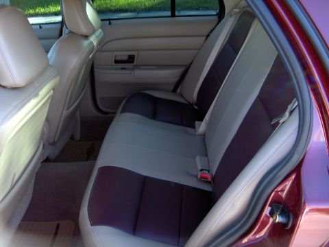 2004 Ford Crown Victoria - The interior of a 2004 Ford Crown Victoria shows its rear seating area with a two-tone upholstery design.