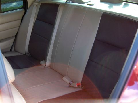 2004 Ford Crown Victoria - Interior view of rear car seats with two-tone upholstery and seatbelts.